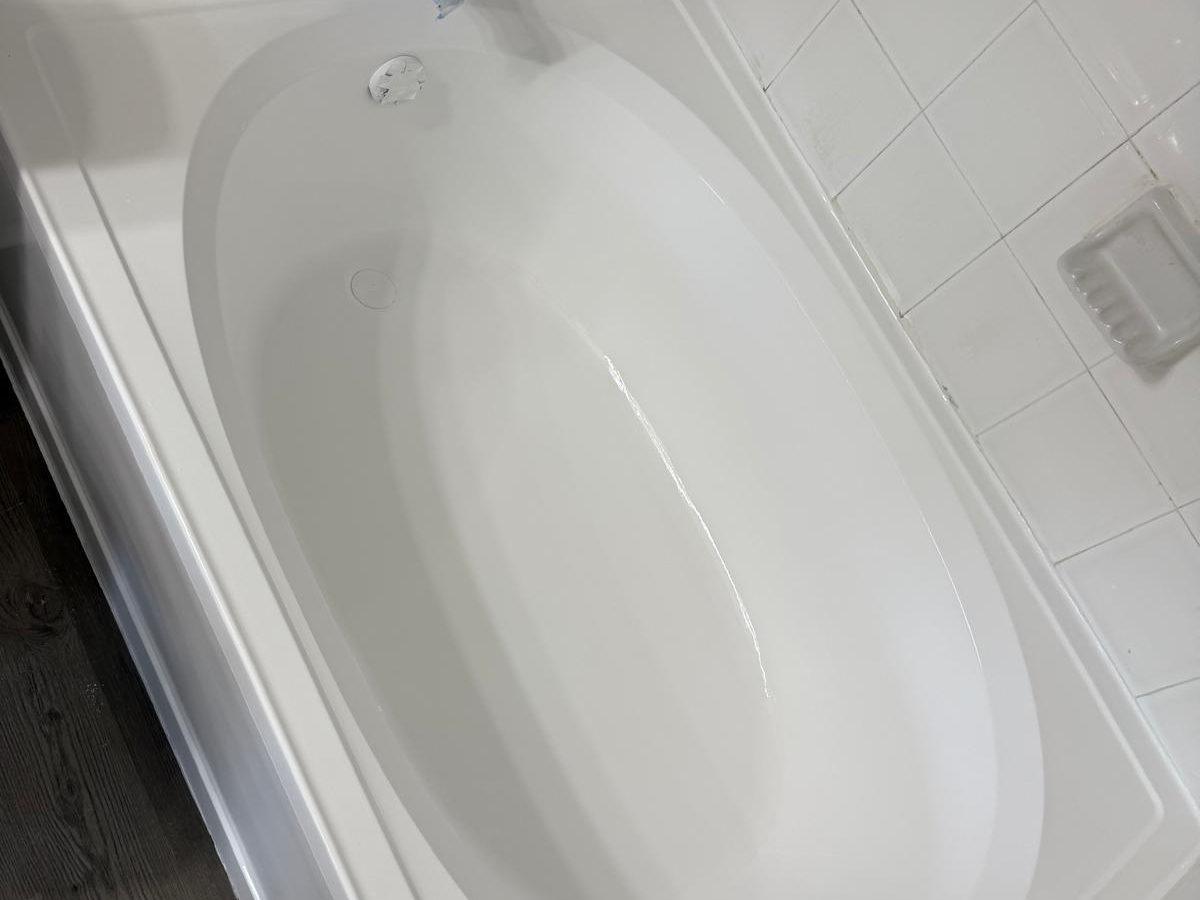 Bathtub restored to a glossy white finish after reglazing